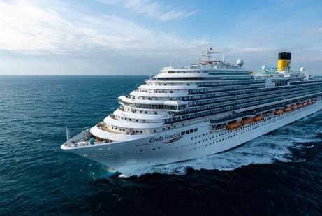 A large white costa cruise ship sails across a calm, vast blue sea under a clear blue sky, conveying a serene and relaxing atmosphere.