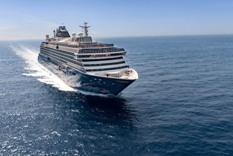A Greek Isle explora large cruise ship sails smoothly across a vast, calm ocean under a clear blue sky, creating a serene and majestic seafaring scene.