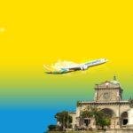 Cebu Pacific airplane flying above the Manila Cathedral in the Philippines