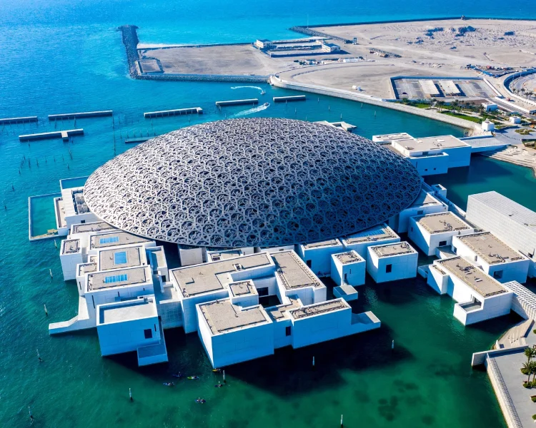 Panoramic view from the rooftop of Louvre Abu Dhabi showing the city skyline and sea