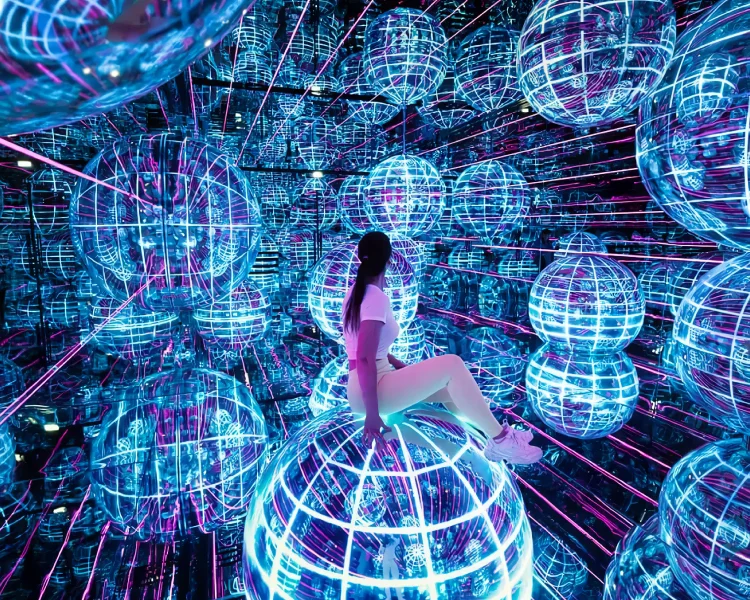 Visitors experiencing colorful interactive digital art installations inside AYA Universe Dubai