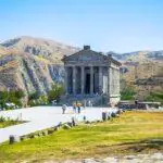 Temple of Garni with scenic mountain backdrop in Armenia"