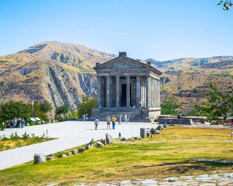 Temple of Garni with scenic mountain backdrop in Armenia"