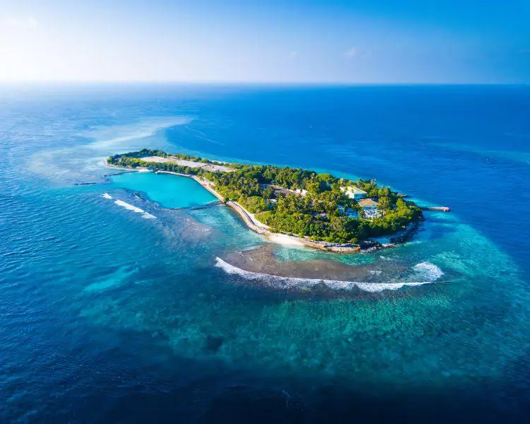 Tropical island in the Maldives surrounded by turquoise waters