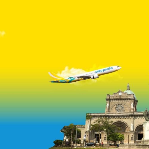 Cebu Pacific airplane flying above the Manila Cathedral in the Philippines
